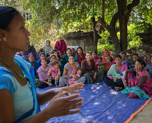 A group of women, including expectant mothers, meet outside in Nepal