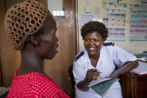 A nurse providing antenatal counseling to a pregnant woman in Uganda