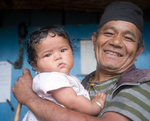 Father holds baby in Nepal