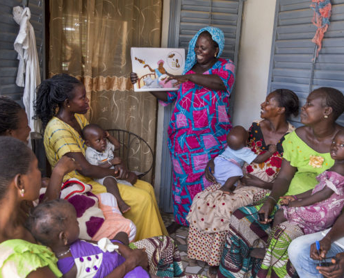 A community health worker provides women in her community counseling and post natal care at her home