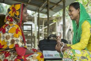 Two women sit talking in Bangladesh