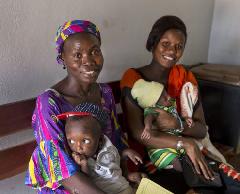 Two women and their babies receiving post natal care at a health center in Senegal