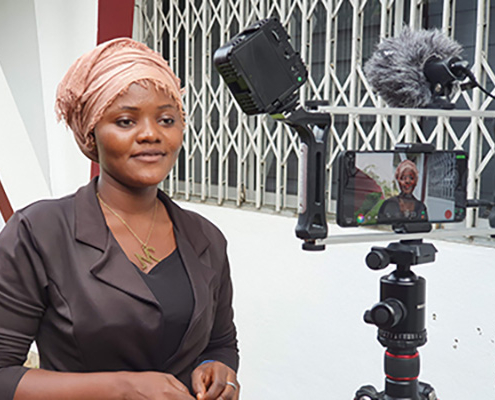 A woman standing in front of a video camera