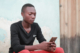 An adolescent on a mobile device in Tanzania