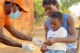 A community health worker uses a rapid malaria test on a young boy in Zambia