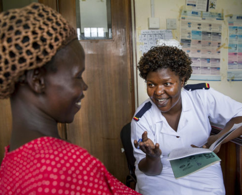 A nurse counseling a pregnant woman at her checkup