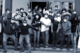 A group photo of people wearing face masks celebrating