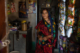 A community volunteer poses outside her grocery store in India