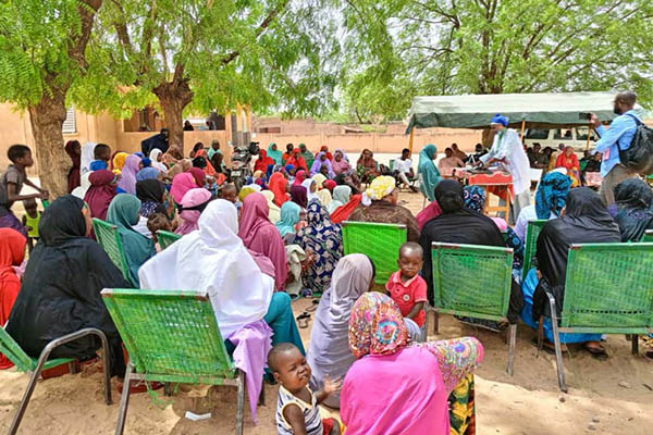 Community members gather to pilot a new family planning counseling tool in Niger