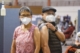 Two older adults with surgical masks and bandages after getting vaccinated in New York City