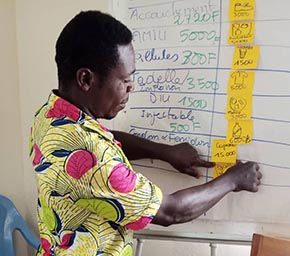 Man participating in a community engagement activity with post-it notes and flip chart
