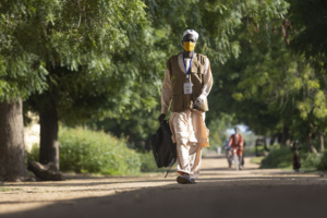 A community health worker walks to see patients in Cameroon