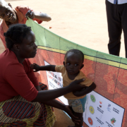 Woman and boy in front of a banner