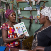 A community health worker providing family planning services and options to a woman in Uganda
