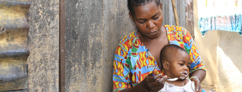 Congolese mother feeding her young child