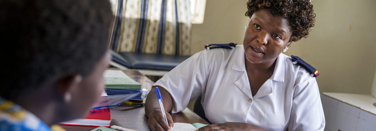 Nurse providing antenatal counseling to a pregnant woman in Uganda