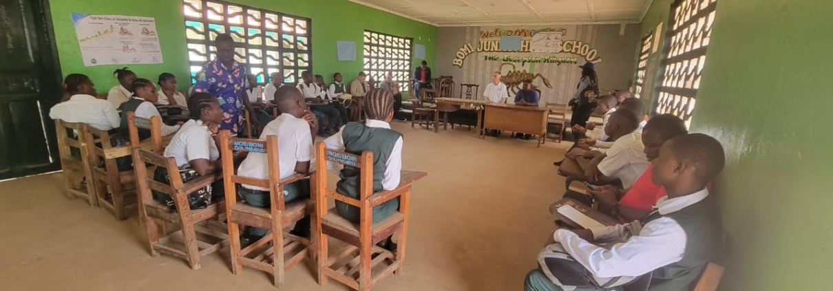 Students sitting in a circle in a high school classroom in Bomi County, Liberia.