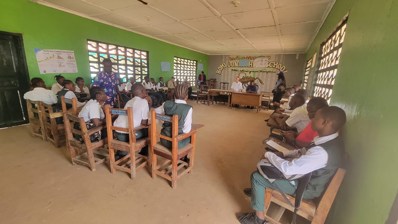 Students sitting in a circle in a high school classroom in Bomi County, Liberia.