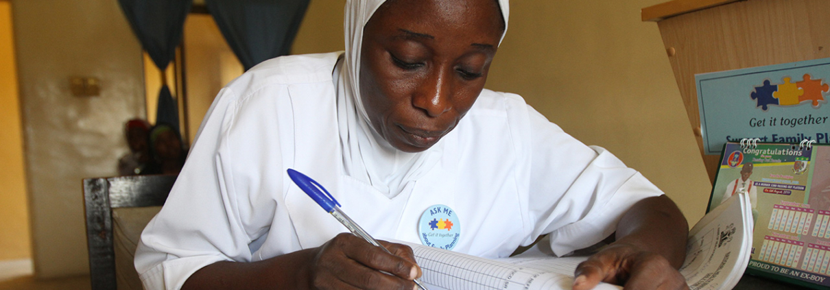 A family planning service provider in Nigeria records information into a records register