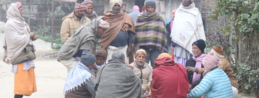 Several men gather around the Ghur in Nepal