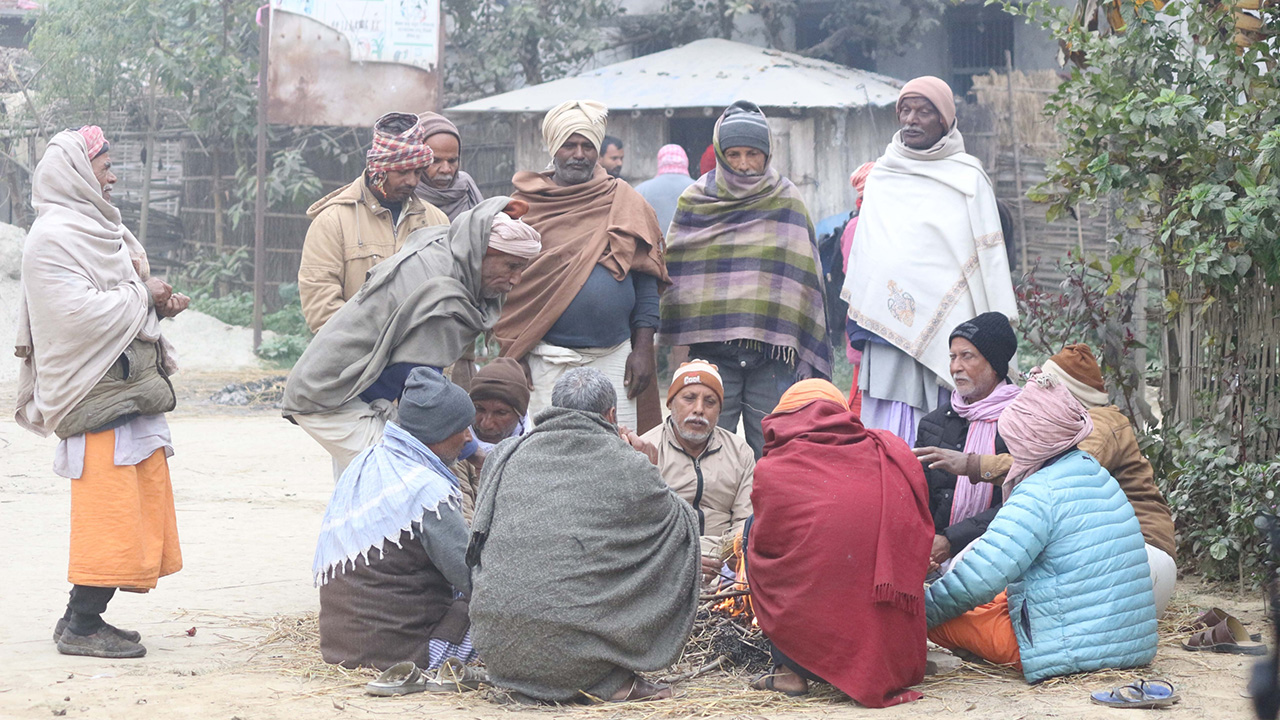 Several men gather around the Ghur in Nepal