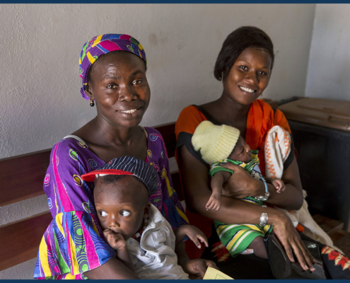 Two women and their babies receiving post natal care at a health center in Senegal