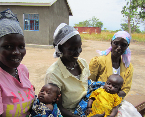 Two mothers holding their babies in South Sudan