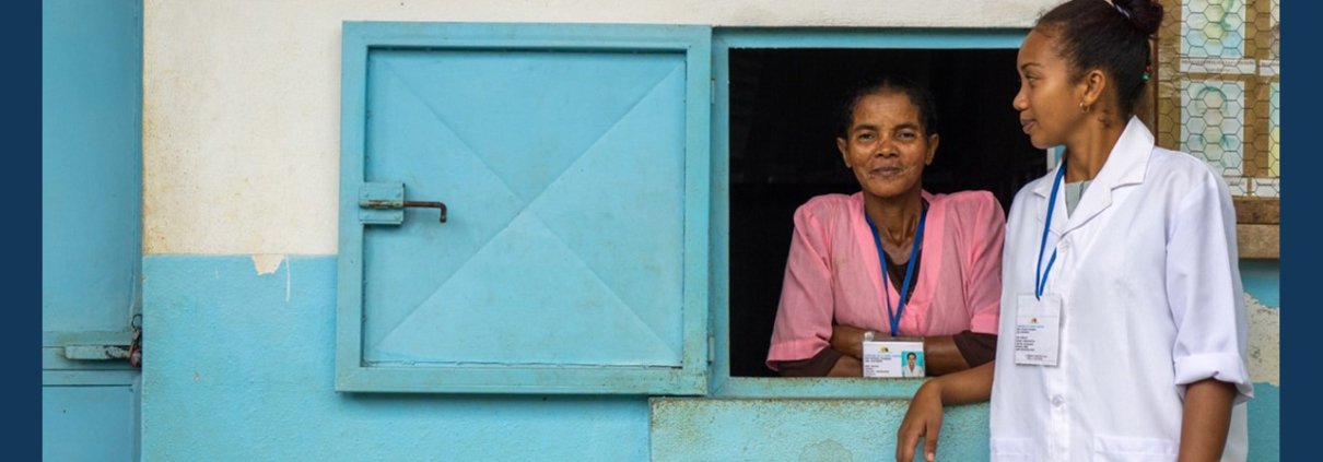 A health provider stands outside a pharmacy in Madagascar