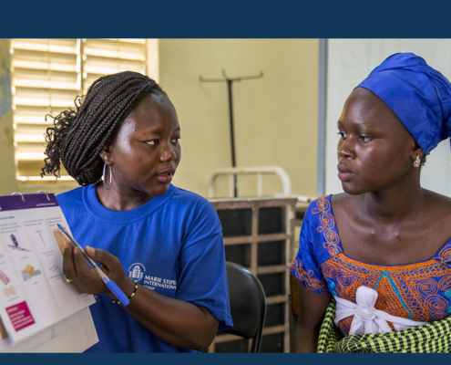 A female health worker provides reproductive health and family planning counseling to a woman in Senegal