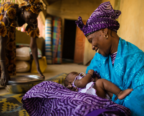 A Senegalese mother smiles at her newborn daughter