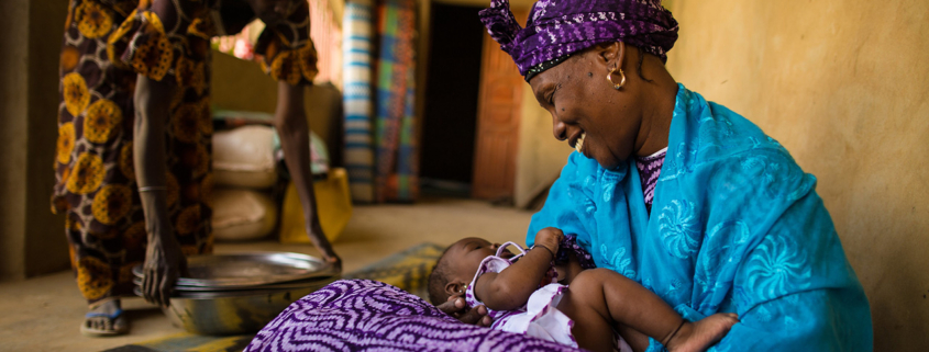 A Senegalese mother smiles at her newborn daughter