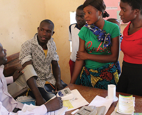 Adolescent receiving blood pressure check