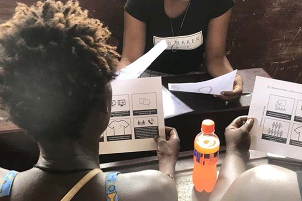 Parents engaged during a prototype testing session in the DRC