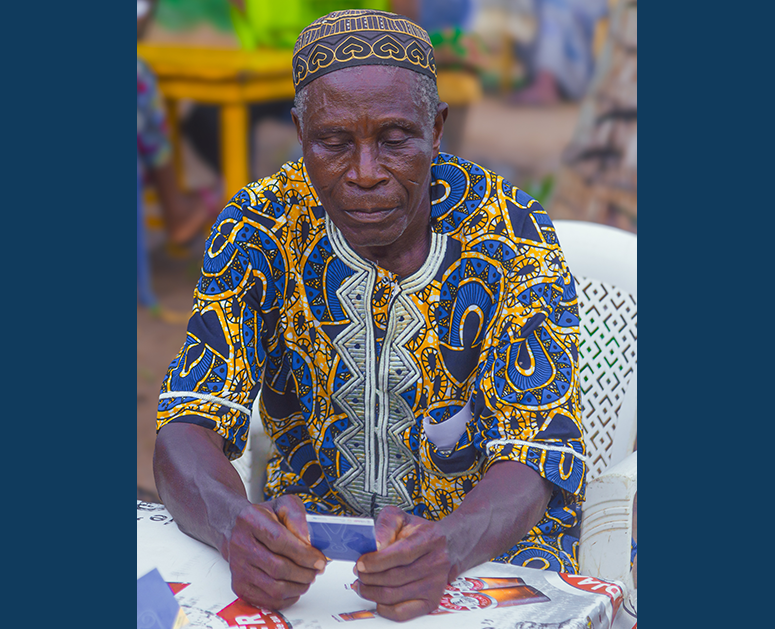 Elder male playing Empathways in Togo