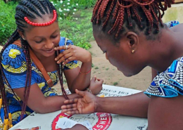 Two females playing Empathways in Togo.