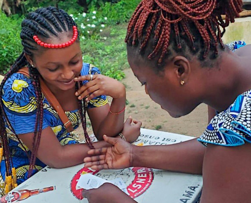 Two women playing Empathways in Togo