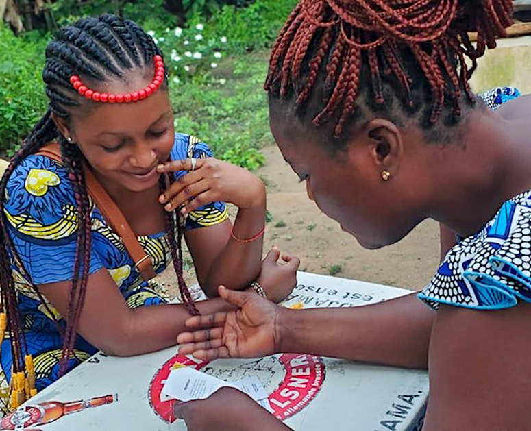 Two females playing Empathways in Togo.