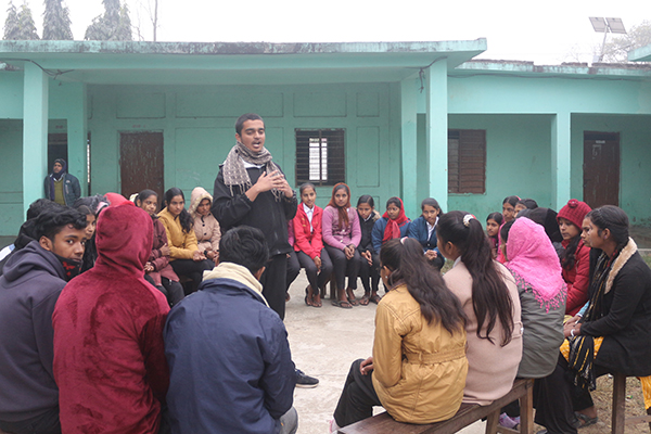 An adolescent boy leads a child club meeting in Madhesh Province, Nepal.