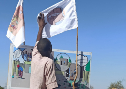 Man looks at WASH flags during a user-testing session in Niger