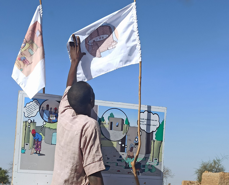 Man looks at WASH flags during a user-testing session in Niger