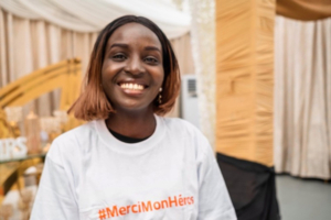 Young woman wearing a Merci Mon Héros t-shirt in the DRC