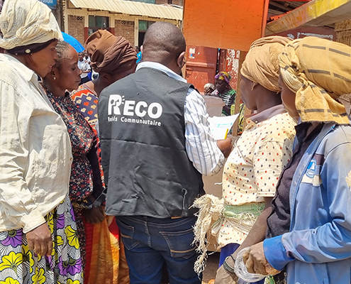 A RECO interacting with community members in the DRC