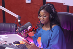 Nigerian woman reading a radio script on World Malaria Day