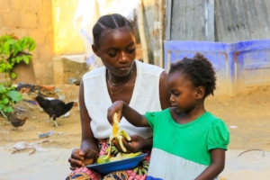 mother feeding a child fruit