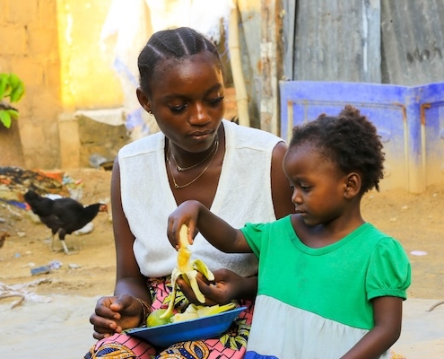 mother feeding a child fruit